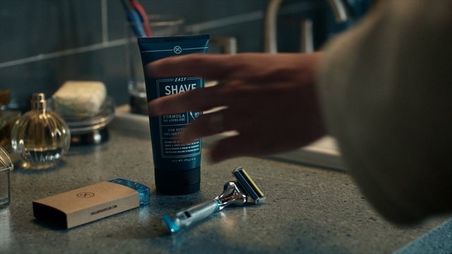 Video Reference: bathroom, countertop, shaving cream, razor, grooming, men's care, product shot, hand, sink, mirror, toiletries, close-up