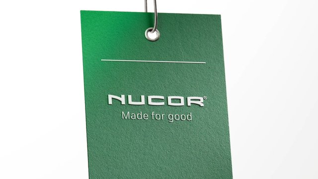 Video Reference: hanging tag, cardboard, green, brand logo, text, product tag, close-up, minimal, white background, industrial, marketing, signage