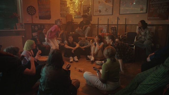 Video Reference: Picture frame, Chair, Crowd, Event, T-shirt, Fun, Conversation, Room, Visual arts, Suit