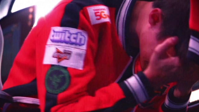 Video Reference: Sleeve, Gesture, Font, Event, Personal protective equipment, Magenta, Audio equipment, Carmine, Electric blue, Public event