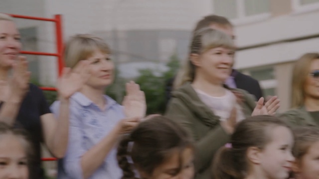 Video Reference: Hair, Gesture, Happy, Fun, Leisure, Event, Child, T-shirt, Crowd, Team