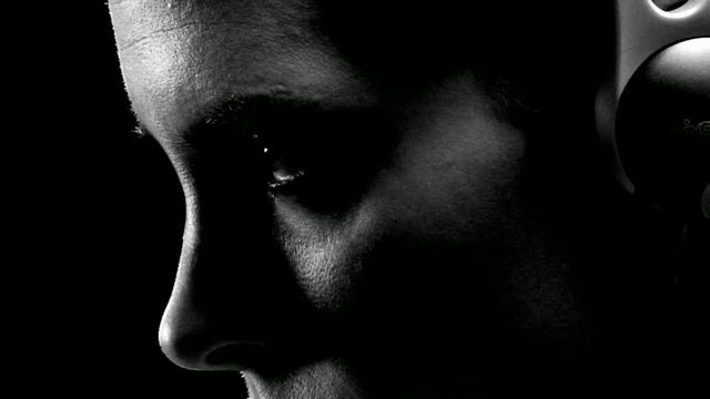 Video Reference: portrait, close-up, side profile, black and white, low light, face, person, dramatic lighting, shadow, eye, nose, minimalist, abstract, silhouette
