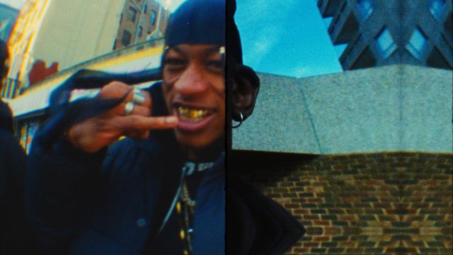 Video Reference: split screen, close-up, person, hood, gold teeth, hand gesture, urban, building, sky, street, portrait, outdoor, music video, gritty, low light