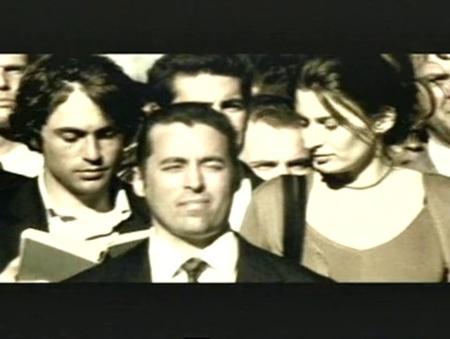 Video Reference: Eyebrow, Coat, Flash photography, Gesture, Tie, Suit, Formal wear, Font, Friendship, Blazer