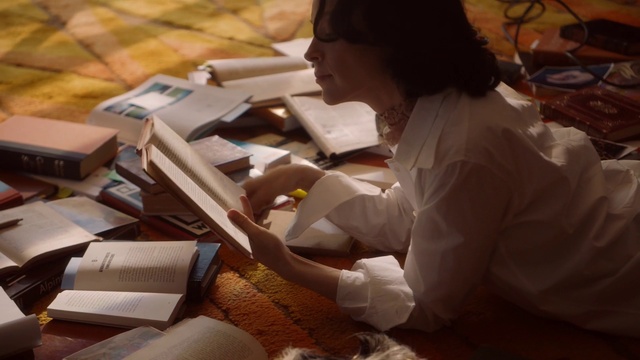 Video Reference: Wood, Office equipment, Publication, Book, Office supplies, Reading, Sitting, Fashion design, Job, Child