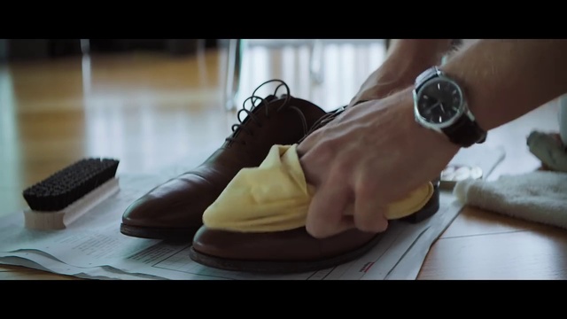 Video Reference: Watch, Black, Comfort, Gesture, Wood, Flooring, Clock, Outdoor shoe, Walking shoe, Sportswear