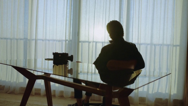 Video Reference: Wood, Curtain, Table, Musician, Art, Window treatment, Shade, Hardwood, Sitting, Room