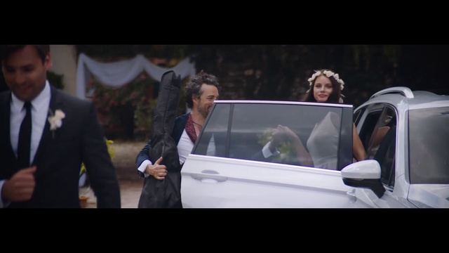 Video Reference: Vehicle, Coat, Motor vehicle, Car, Tie, Automotive design, Gesture, Flash photography, Suit, Vehicle door