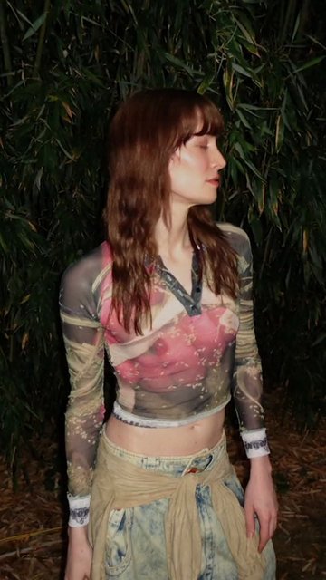 Video Reference: woman, profile, outdoors, night, foliage, portrait, standing, long hair, casual clothing, backdrop, nature, side view