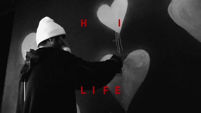 Video Reference: Flash photography, Sleeve, Standing, Gesture, Font, Art, Cap, Darkness, T-shirt, Elbow