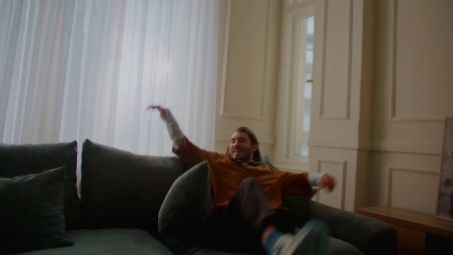 Video Reference: Jeans, Comfort, Curtain, Knee, Floor, Thigh, Living room, Wood, Couch, Smile