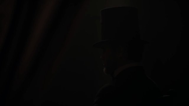 Video Reference: silhouette, top hat, profile, dark, low light, portrait, costume, theatrical, mystery, shadow