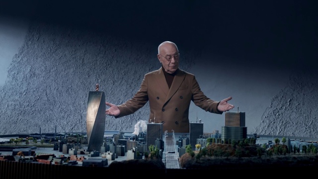 Video Reference: Sky, Flash photography, Gesture, City, Tower block, Performing arts, Event, Entertainment, Tree, Suit