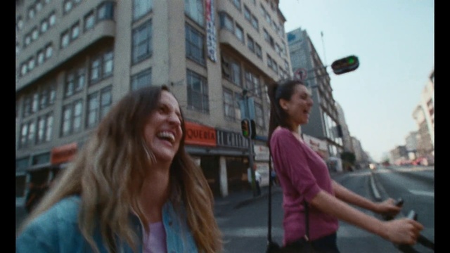 Video Reference: Smile, Hairstyle, Sky, Building, Daytime, Window, Eyewear, Travel, Street fashion, Happy
