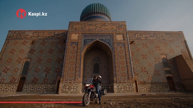 Video Reference: Tire, Wheel, Sky, Natural environment, Temple, Vehicle, Wall, Travel, Morning, Building