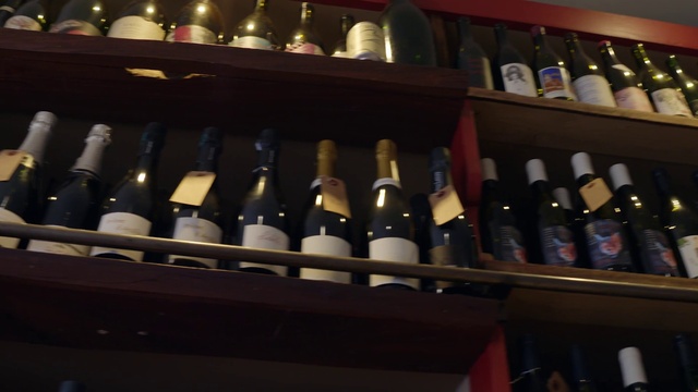 Video Reference: Bottle, Furniture, Glass bottle, Wine cellar, Winery, Alcoholic beverage, Shelf, Drink, Wine bottle, Shelving