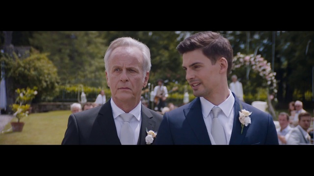 Video Reference: Hairstyle, Coat, Flash photography, Tie, Dress shirt, Happy, Gesture, Collar, Suit, Tree