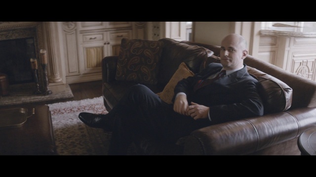 Video Reference: Couch, Comfort, Leg, Flash photography, Beard, Living room, Facial hair, Wood, Eyewear, Flooring