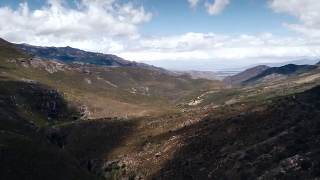 Video Reference: Cloud, Sky, Mountain, Plant community, Slope, Terrain, Tree, Plant, Grassland, Road