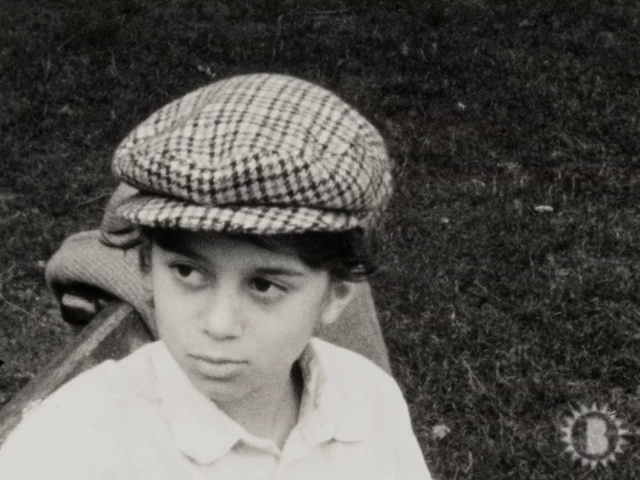 Video Reference: Clothing, Flat cap, Cap, Black, Hat, Headgear, Vintage clothing, Child, Monochrome, Monochrome photography