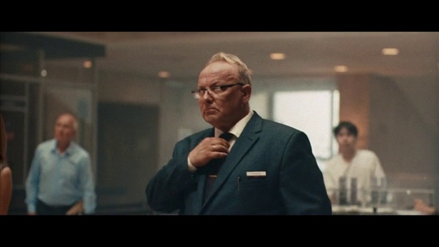 Video Reference: Glasses, Microphone, Gesture, Sleeve, Suit, Event, Formal wear, Official, White-collar worker, Hearing