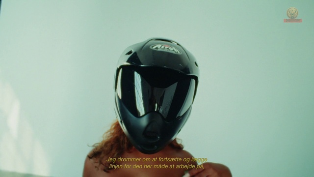 Video Reference: Helmet, Sports gear, Gesture, Audio equipment, Sculpture, Personal protective equipment, Art, Sports equipment, Electric blue, Fictional character