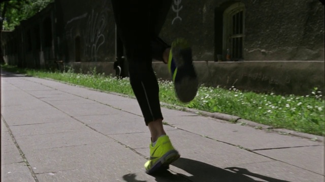 Video Reference: Plant, Road surface, Asphalt, Knee, Grey, Thigh, Street fashion, Sidewalk, Grass, Rolling