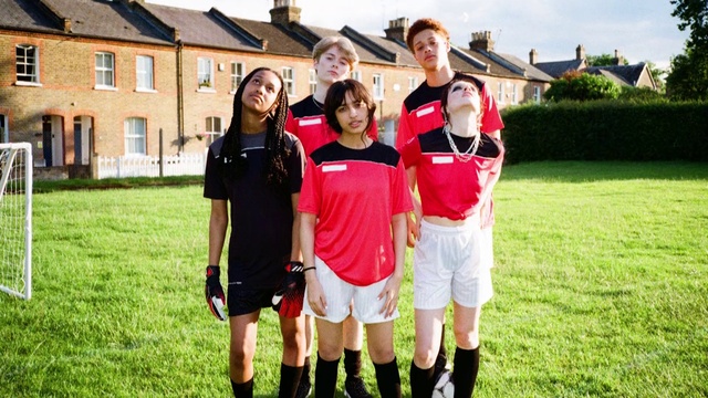 Video Reference: Shorts, Smile, Active shorts, Sports uniform, Plant, Sports equipment, Window, Gesture, Sky, Grass