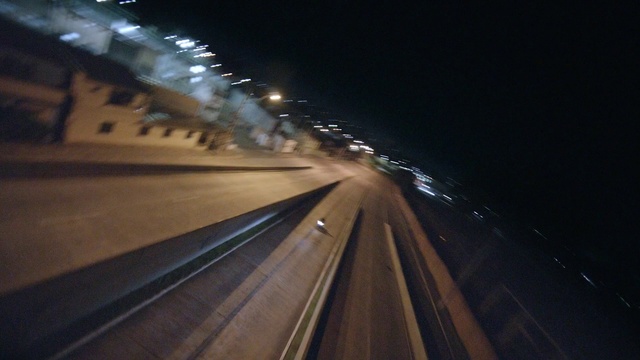 Video Reference: Building, Automotive lighting, Midnight, Road surface, City, Tints and shades, Road, Electricity, Symmetry, Darkness