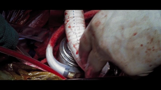 Video Reference: close-up, gloved hand, hoses, tubing, metal parts, clutter, container, industrial, maintenance, medical, red stains, macro, equipment, dirty, abstract