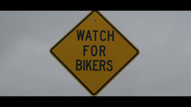 Video Reference: Vertebrate, Triangle, Font, Street sign, Asphalt, Symbol, Signage, Road, Rectangle, Metal
