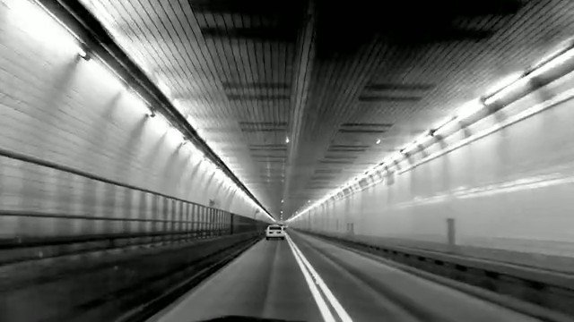 Video Reference: tunnel, road, car, vehicle, interior, black and white, leading lines, perspective, motion, transportation, travel, vanishing point, lane markings, underground, driving