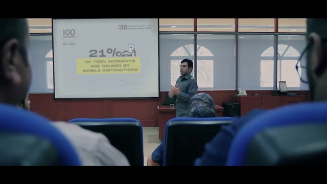 Video Reference: Chair, Projection screen, Technology, Presentation, Event, Electronic device, Projector accessory, Display device, Public speaking, Job