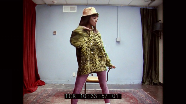 Video Reference: Curtain, Sleeve, Fedora, Waist, Hat, Flash photography, Fashion design, Headgear, Flooring, Baseball cap
