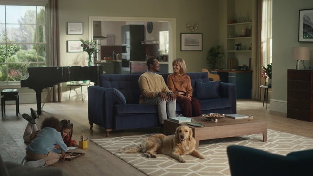 Video Reference: Couch, Property, Furniture, Picture frame, Dog, Comfort, Plant, Window, Interior design, Lighting