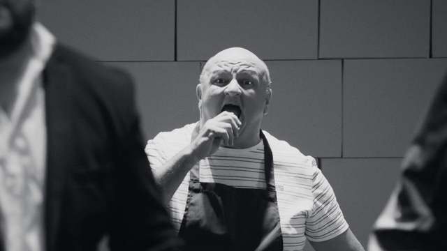 Video Reference: Microphone, Gesture, Black-and-white, Grey, Style, Performing arts, Entertainment, Audio equipment, Music artist, Music