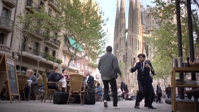 Video Reference: Footwear, Daytime, Building, Window, Sky, Road surface, Tree, Chair, Sidewalk, Travel