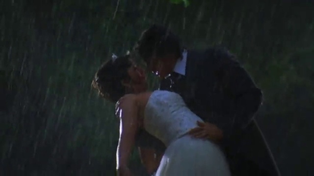 Video Reference: Wedding dress, Bride, Kiss, Flash photography, Dress, Gesture, Bridal clothing, Happy, Formal wear, Bridal accessory