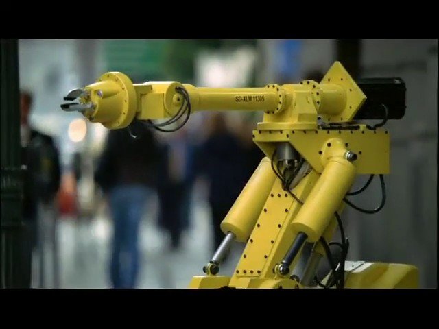 Video Reference: industrial robot, robotic arm, automation, factory, manufacturing, technology, machine, mechanical arm, yellow, engineering, industry, equipment, robotics, display, blurred background