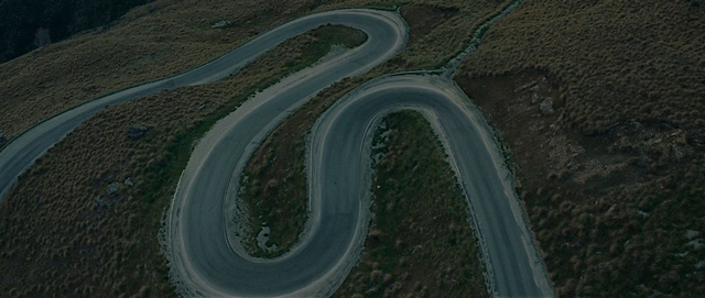 Video Reference: Asphalt, Road surface, Oxbow lake, Race track, Thoroughfare, Landscape, Road, Urban design, Natural landscape, Tar