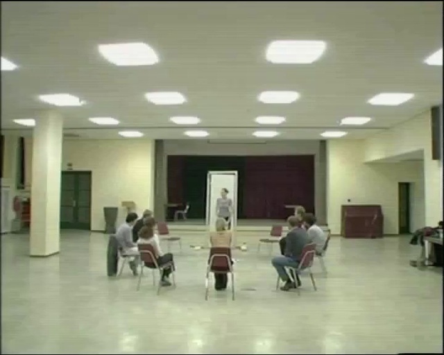 Video Reference: Chair, Fixture, Building, Interior design, Floor, Flooring, Hall, Event, Automotive design, Ceiling