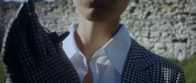 Video Reference: Outerwear, Dress shirt, Neck, Street fashion, Sleeve, Gesture, Grey, Collar, Blazer, Formal wear