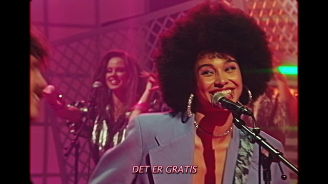 Video Reference: Microphone, Smile, Musician, Purple, Music, Artist, Music artist, Entertainment, Public address system, Performing arts