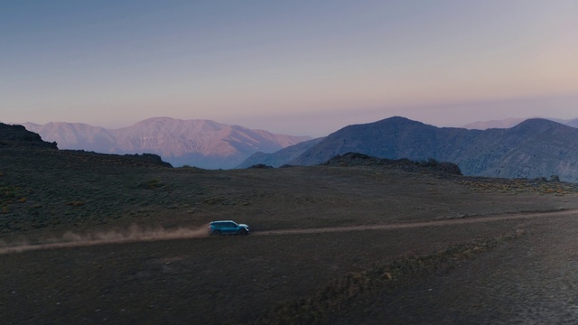 Video Reference: Sky, Mountain, Vehicle, Tire, Car, Terrain, Asphalt, Landscape, Plain, Grassland