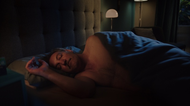 Video Reference: Comfort, Mouth, Flash photography, Neck, Lamp, Facial hair, Bed, Black hair, Chest, Wood