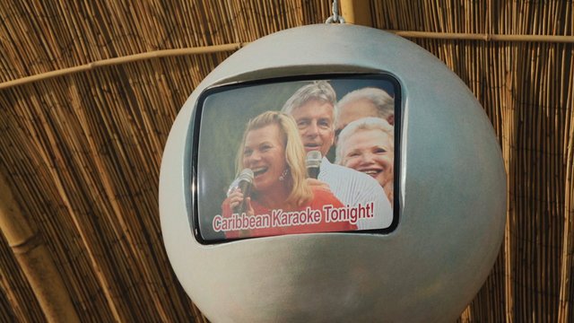 Video Reference: television, display, hanging, spherical, bamboo, ceiling, karaoke, promotional, text, indoor, close-up, screen, people, smiling, entertainment, signage