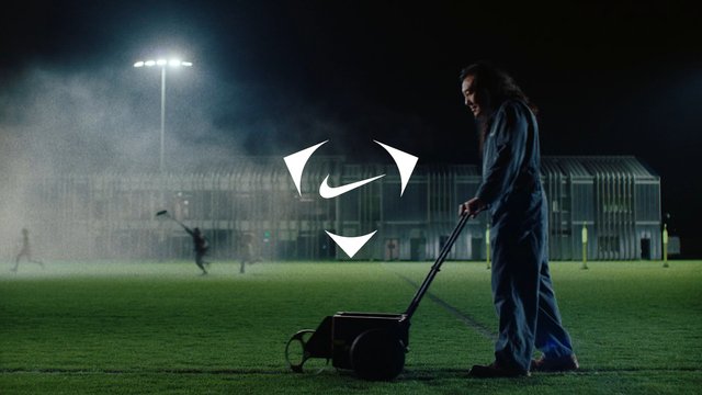 Video Reference: sports field, night, groundskeeper, line marking, wet grass, stadium lights, mist, maintenance, outdoor, equipment, worker, turf, field, silhouette, drama