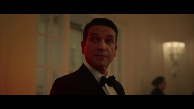 Video Reference: Forehead, Eyebrow, Flash photography, Dress shirt, Microphone, Formal wear, Event, White-collar worker, Facial hair, Official