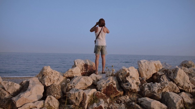 Video Reference: Water, Sky, Shorts, Leg, Human body, Coastal and oceanic landforms, Travel, People in nature, Horizon, Landscape