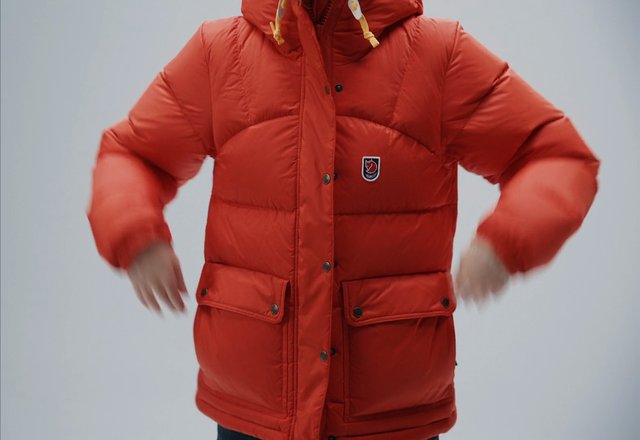 Video Reference: red jacket, puffer coat, winter clothing, outerwear, person, torso, fashion, apparel, standing, motion blur, plain background, casual wear